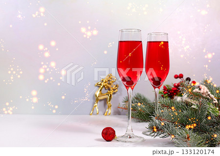 Christmas alcoholic cocktail with red champagne "Mimosa" with cranberry in glasses on a festive background with fir branches and decorations, bar and Christmas Eve concept, alcoholic drinks at a party Christmas alcoholic cocktail with red champagne "Mimosa" with cranberry in glasses on a festive background with fir branches and decorations, bar and Christmas Eve concept, alcoholic drinks at a party 133120174