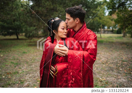 Loving interracial couple celebrating traditional Chinese wedding ceremony Loving interracial couple celebrating traditional Chinese wedding ceremony 133120224