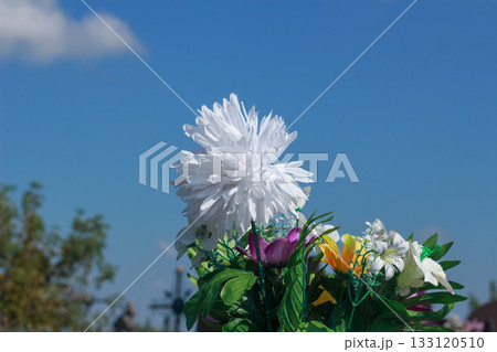 White Artificial Flower Bouquet Against Blue Sky White Artificial Flower Bouquet Against Blue Sky 133120510