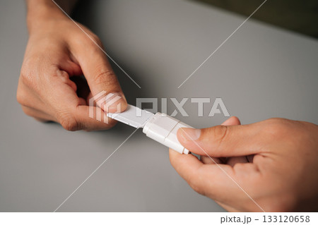 Closeup male hands inserting micro sd card into usb adapter, enabling data transfer and storage expansion on minimalist gray surface. Concept of computer hardware Closeup male hands inserting micro sd card into usb adapter, enabling data transfer and storage expansion on minimalist gray surface. Concept of computer hardware 133120658
