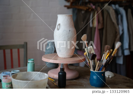 Ceramist workplace. Pottery studio workshop. Handmade clay vase. Potter place of work. 133120965