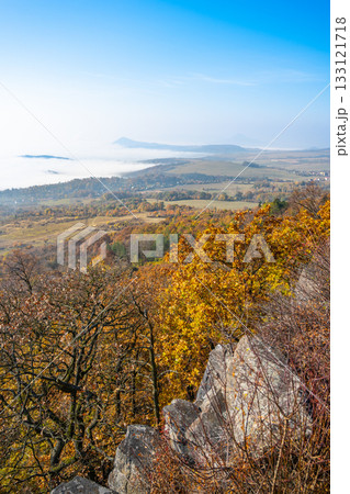Visitors enjoy a breathtaking autumn view from Laffita Lookout Point, where vibrant foliage contrasts with misty valleys and distant mountains in the Central Bohemian Uplands. Visitors enjoy a breathtaking autumn view from Laffita Lookout Point, where vibrant foliage contrasts with misty valleys and distant mountains in the Central Bohemian Uplands. 133121718