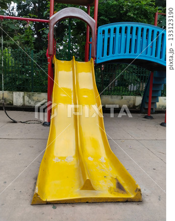 Colorful childrens playground set with slides, bridge, climbing stairs, swings and canopies in public park, designed for kids recreation, fun and physical activity in a safe and vibrant outdoor 133123190
