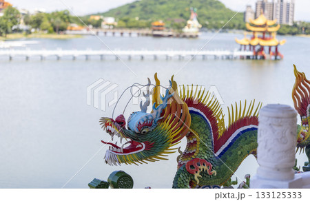 dragon status in lotus pond, an artificial lake and popular tourist destination at Zuoying District in Kaohsiung. the far view of building is Wuli Pavilion dragon status in lotus pond, an artificial lake and popular tourist destination at Zuoying District in Kaohsiung. the far view of building is Wuli Pavilion 133125333