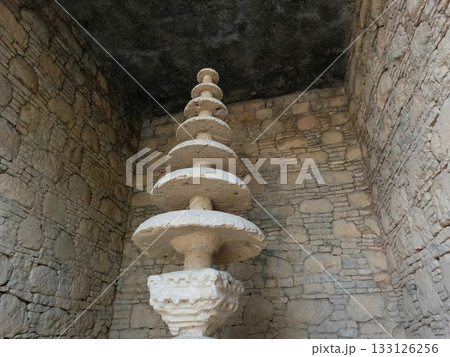 Heritage votive stupa with tiered stone layers Taxila 133126256
