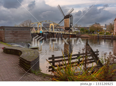 Windmill and canal in Leiden Netherlands at sunrise 133126925