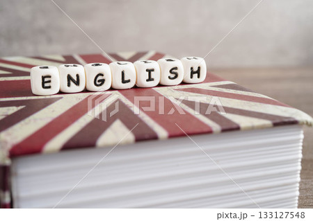 English book with graduate hat, learning and tutorial for foreigner. English book with graduate hat, learning and tutorial for foreigner. 133127548