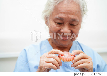 Doctor holding teeth denture in hand for dentist studying about dentistry. Doctor holding teeth denture in hand for dentist studying about dentistry. 133127632