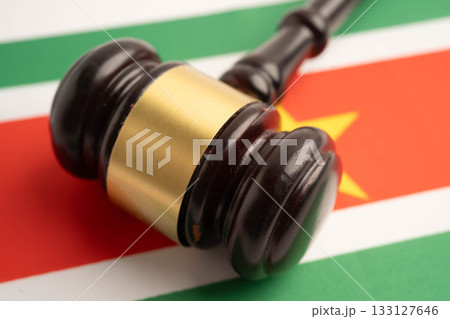 Suriname law, Legal, justice and agreement, wooden court gavel on flag. Suriname law, Legal, justice and agreement, wooden court gavel on flag. 133127646