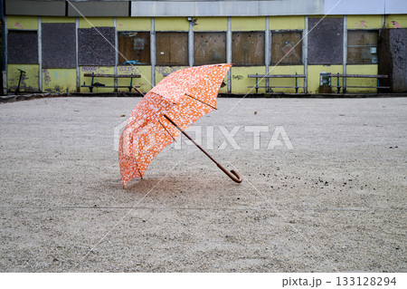 Orange umbrella open on ground Orange umbrella open on ground 133128294