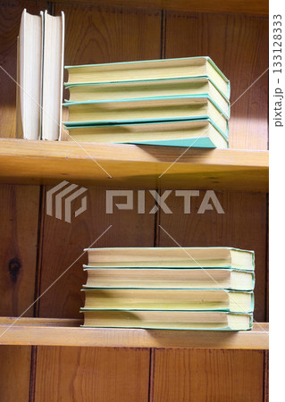 Old vintage books on wooden shelves Old vintage books on wooden shelves 133128333