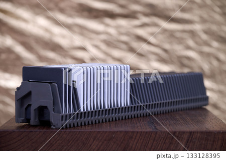 Slide rack for projection against golden background 133128395