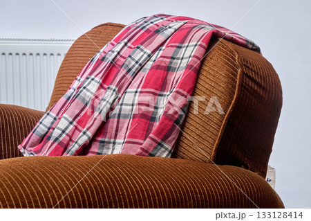 Shirt on the back of an armchair 133128414
