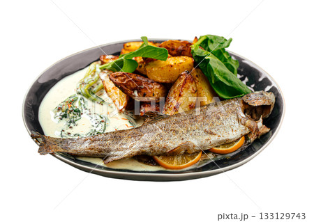 Baked whole trout with potatoes and creamy sauce Baked whole trout with potatoes and creamy sauce 133129743
