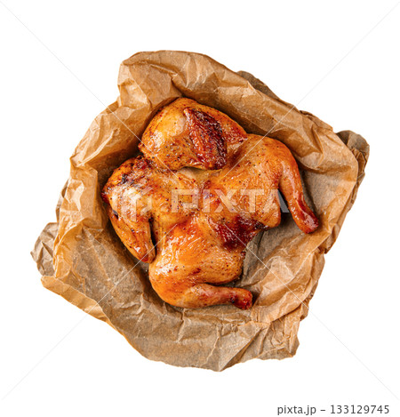 Isolated roasted chicken on parchment sheet Isolated roasted chicken on parchment sheet 133129745