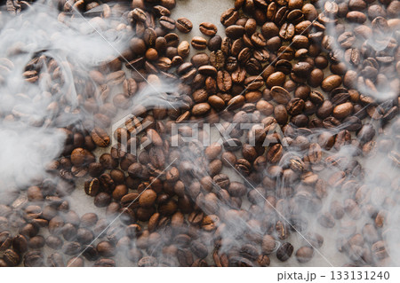 Roasted Coffee Beans Surrounded by Wisps of Steam 133131240