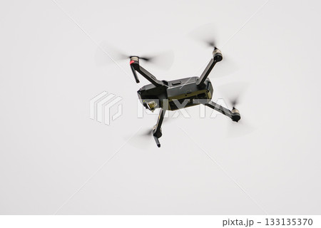 Drone flying over sky background 133135370