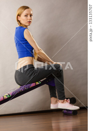 Woman training on bench for sit ups Woman training on bench for sit ups 133135707