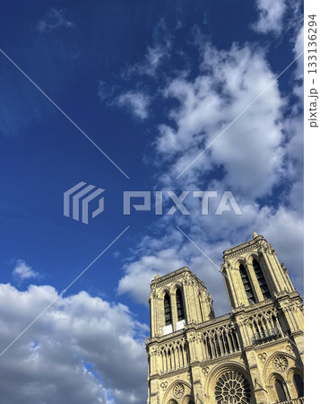 Majestic Notre-Dame Cathedral stands under a bright blue sky in Paris Majestic Notre-Dame Cathedral stands under a bright blue sky in Paris 133136294