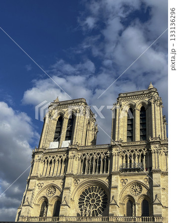 Majestic Notre-Dame Cathedral stands under a bright blue sky in Paris 133136296