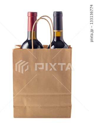 Bottles of red wine in paper bag isolated on a white background. 133136774