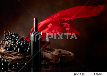 Red wine with grapes on a background of red flutters curtain. Red wine with grapes on a background of red flutters curtain. 133136810
