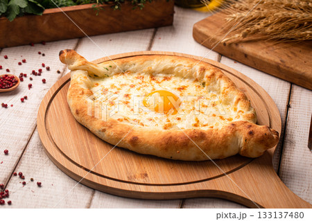 Khachapuri with egg on wooden board 133137480