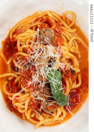 Closeup on pasta with tomato sauce meatballs basil 133137499