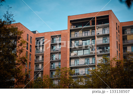 Residential building with balconies surrounded by trees Residential building with balconies surrounded by trees 133138507