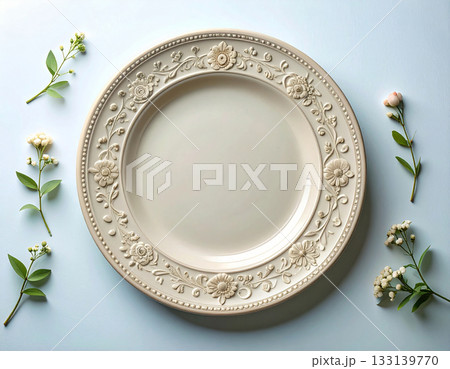 Traditional elegance. Ceramic plate with a classic white design and floral border on a white background. Porcelain kitchenware. Close-up. Top view. 133139770