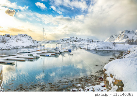 Unbelivable winter scenery with yachts and boats nier pier in small fishing village and snowy mountain peaks near Valberg Unbelivable winter scenery with yachts and boats nier pier in small fishing village and snowy mountain peaks near Valberg 133140365
