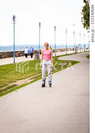Active young woman rollerskating outdoor. Active young woman rollerskating outdoor. 133140686