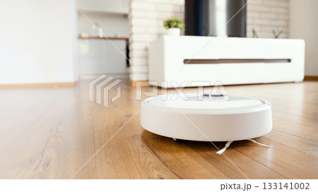 White robot vaccum cleaner in the living room White robot vaccum cleaner in the living room 133141002