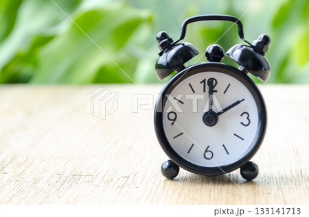 Alarm clock pointing at 2 pm with customizable background space for text or ideas. Time concept. Alarm clock pointing at 2 pm with customizable background space for text or ideas. Time concept. 133141713