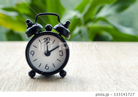 Alarm clock pointing at 2 pm with customizable background space for text or ideas. Alarm clock pointing at 2 pm with customizable background space for text or ideas. 133141727