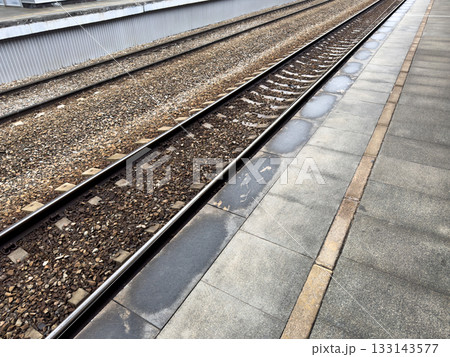 Yellow line on train platform indicates safe distance from the edge of the platform. Railroad safety, stand behind the line when boarding train to prevent accidents 133143577