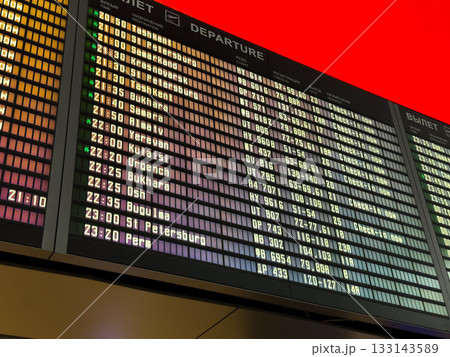 Online flight departure board at the airport. Flight schedules are displayed on the screen. Modern online board with flight numbers and departure times Online flight departure board at the airport. Flight schedules are displayed on the screen. Modern online board with flight numbers and departure times 133143589