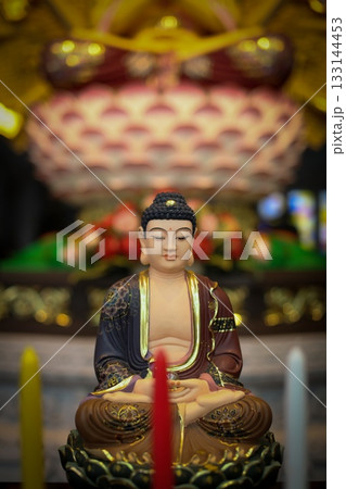 Serene Buddha Statue Amid Colorful Shrine Decor For Meditation, Peace, And Spirituality 133144453