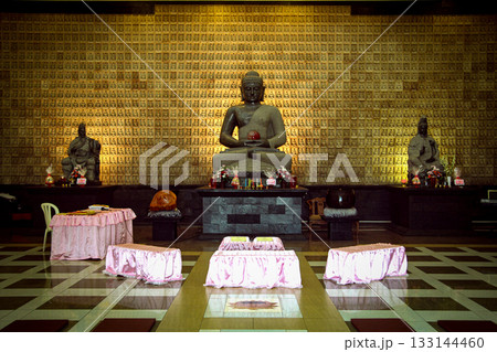 Serene Buddha Statue Amid Colorful Shrine Decor For Meditation, Peace, And Spirituality Serene Buddha Statue Amid Colorful Shrine Decor For Meditation, Peace, And Spirituality 133144460