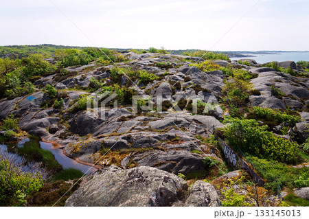 Rocks around public sea bath of Saltholmen peninsula on shore of Alvsborgsfjorden harbour, Alvsborg district, sunny day, Gothenburg, Sweden Rocks around public sea bath of Saltholmen peninsula on shore of Alvsborgsfjorden harbour, Alvsborg district, sunny day, Gothenburg, Sweden 133145013