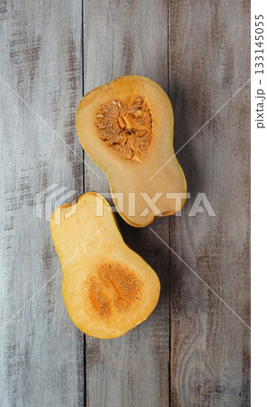 Pieces of ripe pumpkin on the table. Kitchen. Autumn. Cooking. Food background. Thanksgiving. Orange pumpkin. Banner. Pieces of ripe pumpkin on the table. Kitchen. Autumn. Cooking. Food background. Thanksgiving. Orange pumpkin. Banner. 133145055
