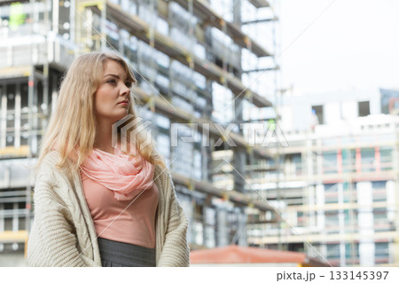 Woman on front of new house building Woman on front of new house building 133145397