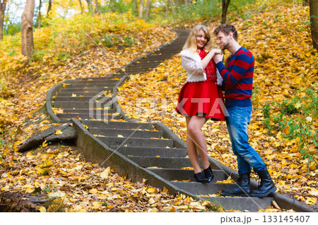 Romantic pair meet in park standing on stairs. Romantic pair meet in park standing on stairs. 133145407