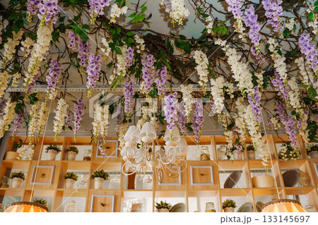 Floral decorations hanging in a cozy cafe interior 133145697
