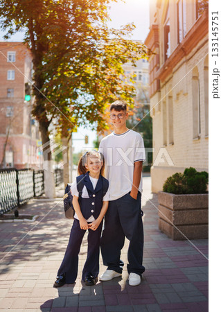 Two siblings enjoying a sunny day on the street near their home Two siblings enjoying a sunny day on the street near their home 133145751