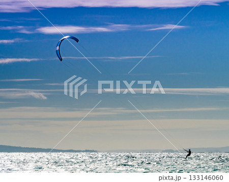Kite surfer riding waves. Kiteboarding sport. Kite surfer riding waves. Kiteboarding sport. 133146060