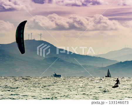Kite surfer riding waves. Kiteboarding sport. 133146073