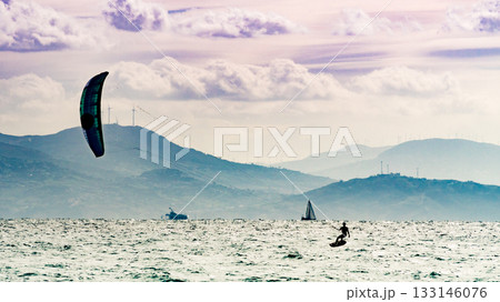 Kite surfer riding waves. Kiteboarding sport. 133146076