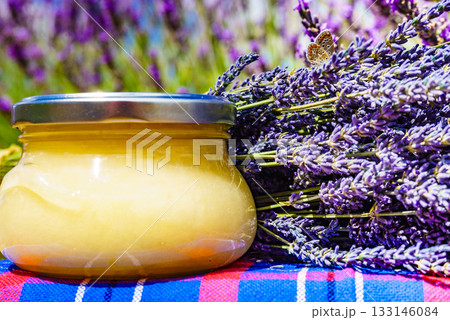 Jar with honey and lavender flowers. 133146084