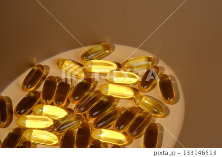 Fish oil omega-3 capsules on a cream background 133146513